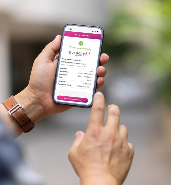 Over shoulder close up view of a man using smartphone include parking payment confirmation