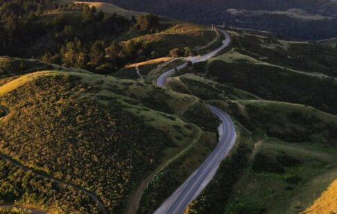 Long winding road through hills at sunset