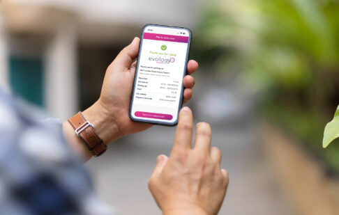 mans hand paying by phone using the Evology Parking app